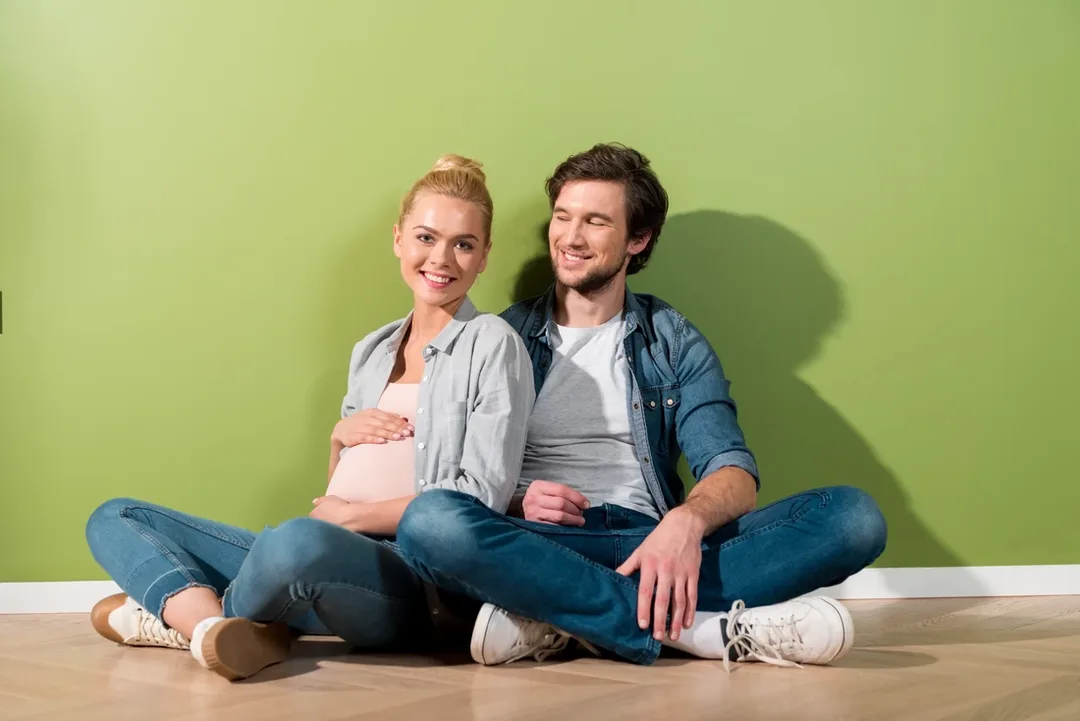 Happy pregnant expat couple
